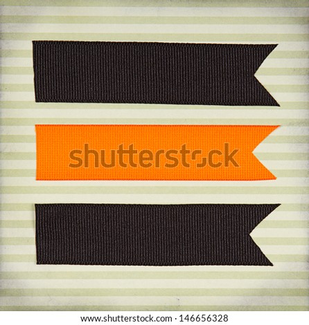 Halloween colored paper tags decorated  on paper background for copy space