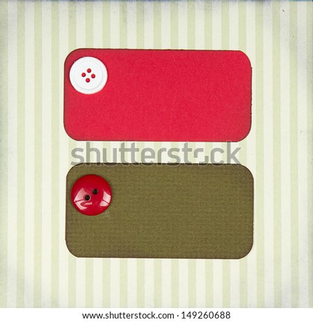 Christmas paper tags with buttons on scrapbook paper background