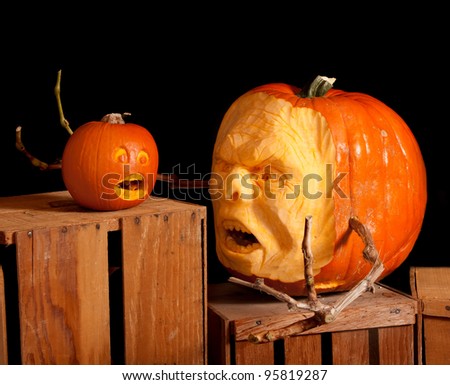 Halloween Jack-o-lantern pumpkin carving very detailed, sitting on wooden crates with a black background