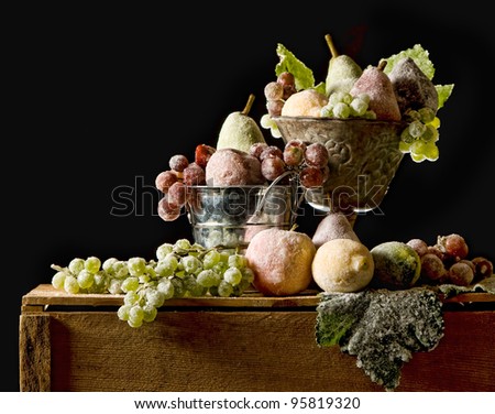 Sugared fruit still life, fruit with a sugar glaze, Christmas or Autumn seasons, black background and room for copy space.