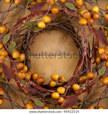 A rustic wreath with golden berries on a wooden background