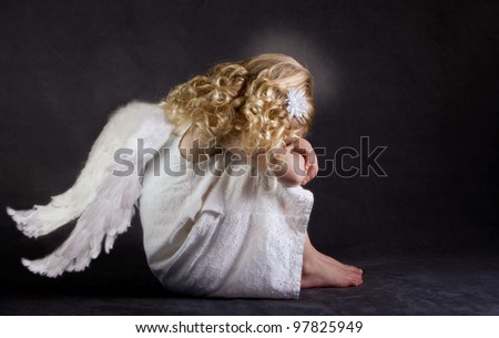 A fallen angel or child angel who is sad