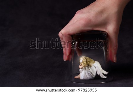 An angel trapped under a glass, a child angel or fallen angel