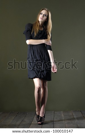 Full length beautiful fashion woman in posing wooden floor