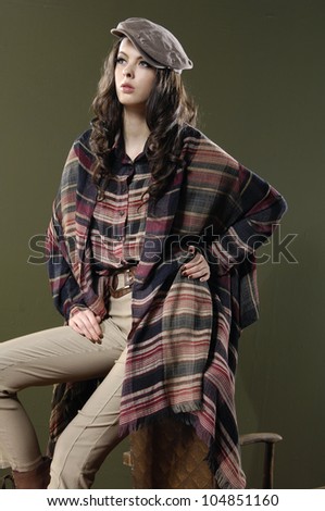 beautiful woman wearing fashion cloth sitting cube on dark background