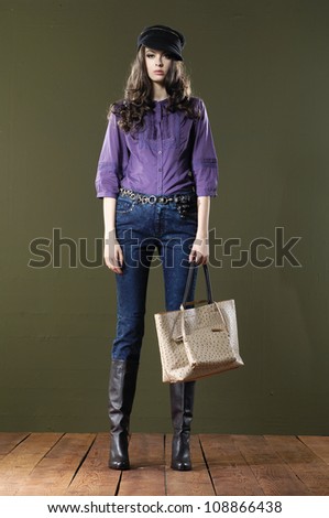 full body fashion woman in handbag posing wooden floor