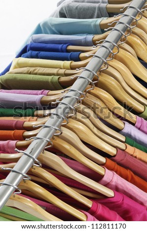 man clothes of different colors shirt on hangers