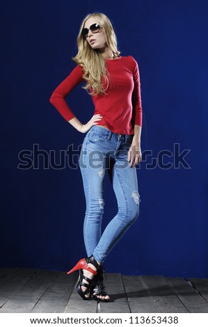 Full length fashion casual girl wearing sunglasses standing posing on wooden floor