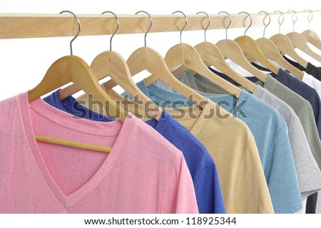 Row of different colors shirt on wooden hangers