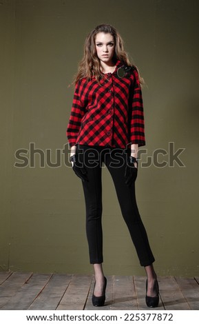 Full length portrait of pretty young woman posing wooden floor