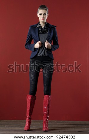 Full length beautiful fashion woman in jacket posing wooden floor