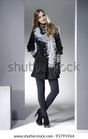 Beautiful fashion casual girl in scarf standing posing