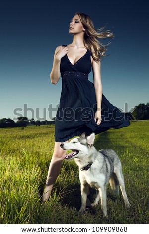 Portrait fashionable girl with a malicious dog. Fashion art photo