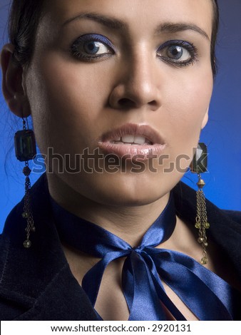 Stylish young lady with a dark blue bow on a dark blue background