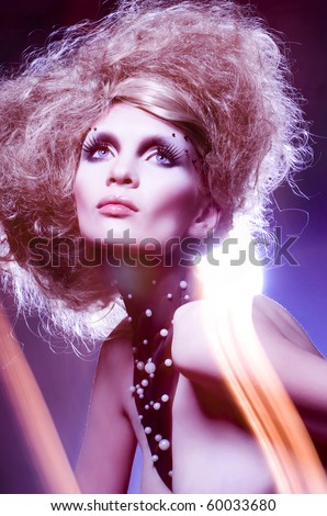 Fashion portrait of sexy woman with an original hairdress and a make-up. Fashion art photo