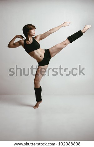 Artistic shot of Beautiful Young Asian Woman Studio Shoot Dancing. Showing Strength, Fitness & Agility.