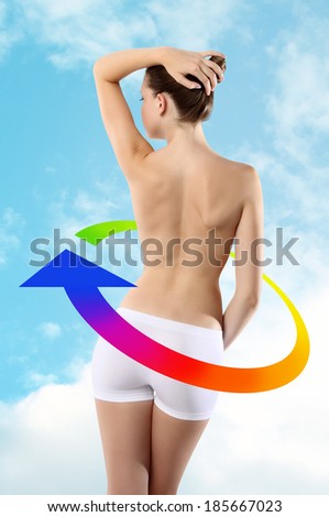 Body of woman ass and back on background of sky with colored arrow