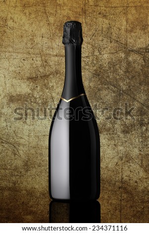 bottle of sparkling wine on colorful gold background