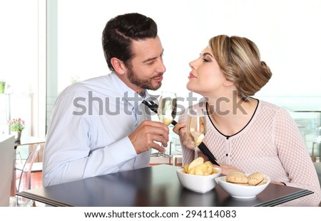 woman pulling the tie to boyfriend, couple love concept
