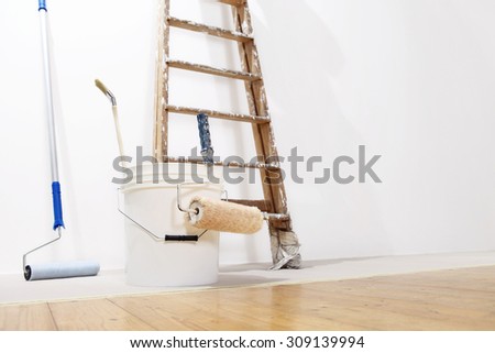 painter wall concept, ladder, bucket, roll paint on the floor