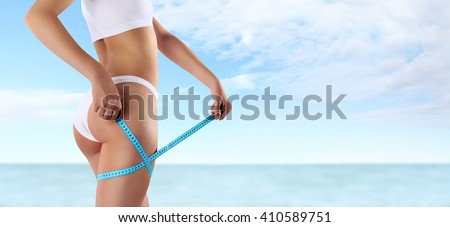 woman holding blue meter with hands on the thigh, isolated on summer sky and sea  background