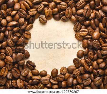 Round Frame from Coffee Beans on the Rustic Brown Paper Background