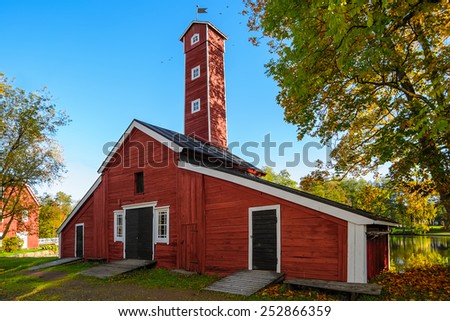 Old factory hose tower of red ochre painted wood at Stromfors Iron Works, Finland.  Iron works was founded in 1698. Stromfors Iron Works got its name in 1744.