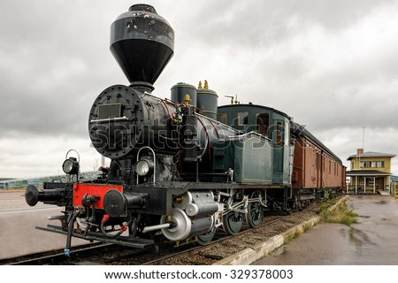 Old steam locomotive with passenger carriages