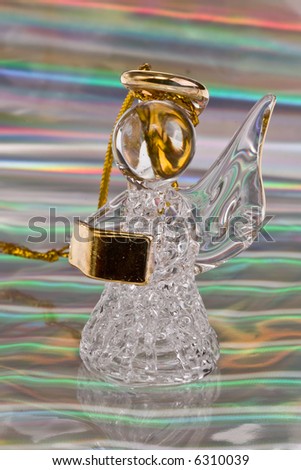 Vintage glass angel figurine on silver stripped background