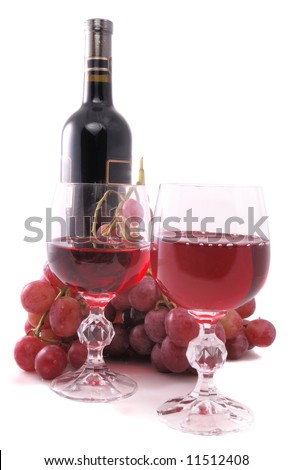 Branch of grapes, bottle of wine and glass on white background