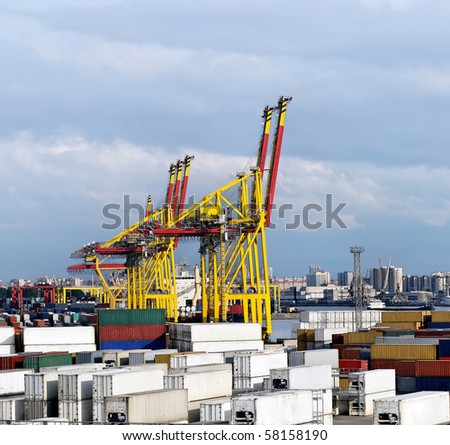 Loading container ship with large gantry cranes in harbour
