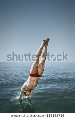 An image of a handsome man jumping in the lake