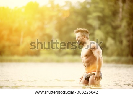 An image of a muscular man in the lake