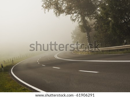 An image of a road covered in fog