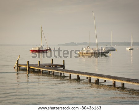 An image of some boats in the early morning mood