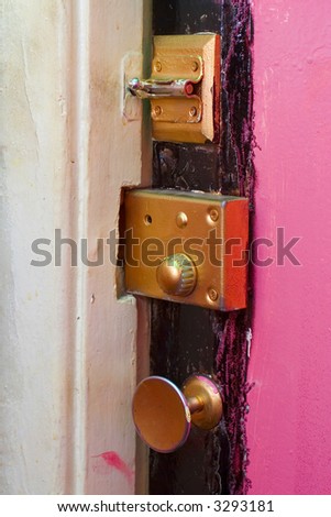 grunge pink door with gold lock