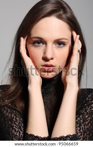 Portrait of beautiful woman with big blue eyes and big lips, looking confused, sensitive, curious