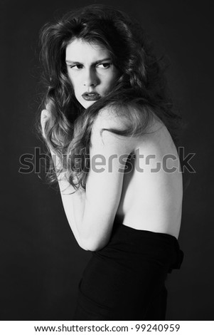 Studio shot of beautiful girl, weared black classic skirt with amazing hairstyle