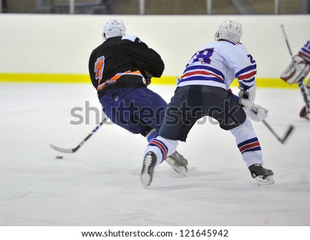 MOSCOW, RUSSIA - JANUARY 27: Unidentified hockey players compete during the Maryino (black) vs NHM (white) at HIMKYl Stadium, score 3-2, on January  27, 2011 in Moscow Russia