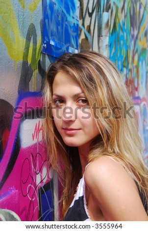 Blondy girl near graphic wall