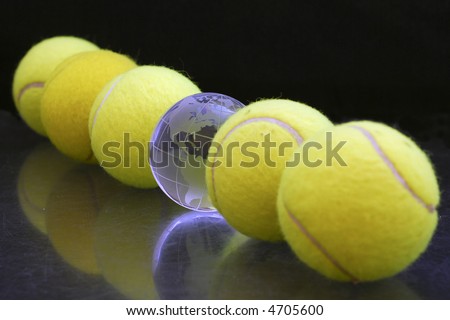 Five tennis balls and one globe