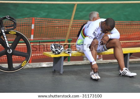 MOSCOW - MAY 29 :  Gregory Bouge of France takes off his cycling shoes after participating in an event during European Track Cycling Cup May 29, 2009 in Moscow, Russia