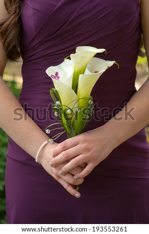 bridesmaid holding lily bouquet
