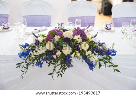 wedding table flowers in white and purple