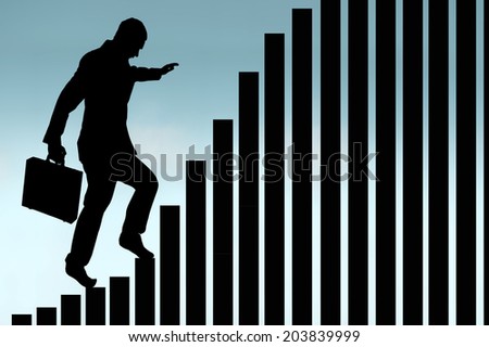 businessman in silhouette climbing a bar chart