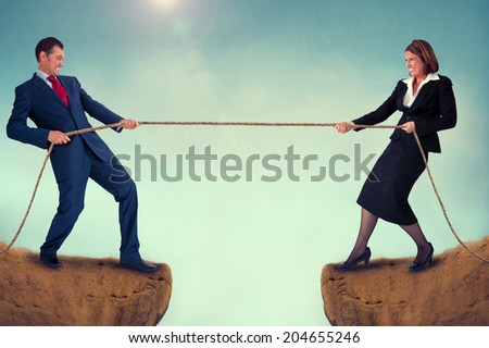 businessman and woman tug of war