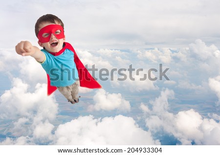 superhero boy child flying mid air above cloud level