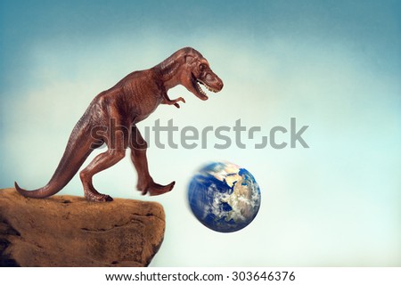 extinction concept dinosaur kicking the planet earth off a precipice with motion blur and vintage filter