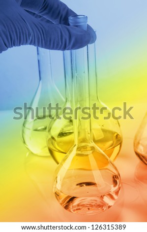 Glass laboratory equipment on colored background