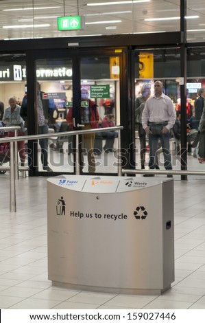 AMSTERDAM, THE NETHERLANDS - OCTOBER 4, 2013: Garbage metal can with recycle sign in the Amsterdam Airport Schiphol on October 4, 2013 in Amsterdam, Netherlands.